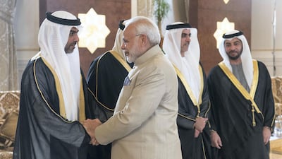 ABU DHABI, UNITED ARAB EMIRATES - February 10, 2018: HH Sheikh Hamed bin Zayed Al Nahyan, Chairman of the Crown Prince Court of Abu Dhabi and Abu Dhabi Executive Council Member (L), receives HE Narendra Modi Prime Minister of India (R), at the Presidential Airport. Seen with HH Sheikh Hamed bin Zayed Al Nahyan, Chairman of the Crown Prince Court of Abu Dhabi and Abu Dhabi Executive Council Member (R) and HH Lt General Sheikh Saif bin Zayed Al Nahyan, UAE Deputy Prime Minister and Minister of Interior (2nd R). ( Rashed Al Mansoori / Crown Prince Court - Abu Dhabi ) ---