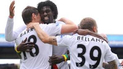 Emmanuel Adebayor, centre, celebrates his winning goal, his third in three games, against Portsmouth yesterday.