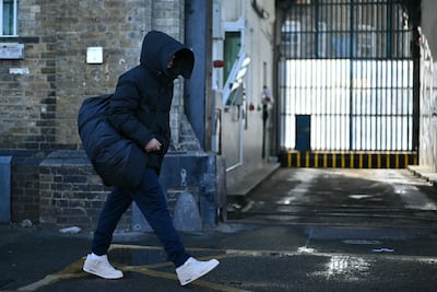 A released prisoner leaves Brixton prison in south London on October 13, 2026, during the second phase of a scheme to free up prison places. (Photo by JUSTIN TALLIS / AFP)