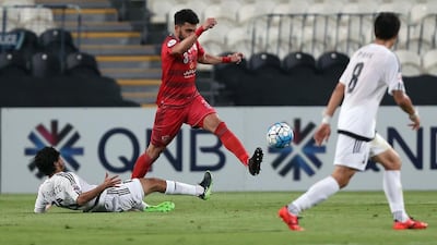 Lekhwiya defender Ahmed Yasser, centre, evades a tackle by Al Jazira's Khalfan Mubarak, left, during their Asian Champions League match on April 25, 2017, at the Mohammed Bin Zayed stadiun in Abu Dhabi. Nezar Balout / AFP