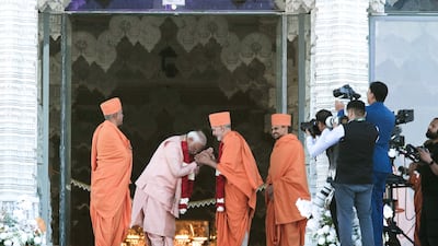 Narendra Modi is greeted by Mahant Swami Maharaj at the new temple