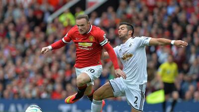 Manchester United’s Wayne Rooney (L) challenges for the ball with Swansea City’s Jordi Amat during the English Premier League soccer match Manchester United vs Swansea City at Old Trafford, Manchester, Britain, 16 August 2014. EPA/PETER POWELL