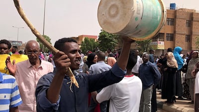 A Sudanese protester bangs on a bucket during a demonstration against the military council, in Khartoum, Sudan, on Sunday, June 30, 2019. AP Photo