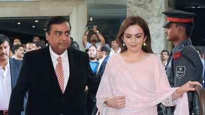 Reliance Industries chairman Mukesh Ambani walks with his wife Nita. Punit Paranjpe / AFP