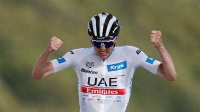 UAE Team Emirates rider Tadej Pogacar celebrates as he crosses the finish line to win Stage 20 of the Tour de France on July 22, 2023. Reuters