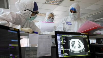 In this Sunday, March 1, 2020 medics wearing protective gear work in a quarantined ward for coronavirus infected patients, at a hospital in Tehran, Iran. Mizan News Agency via AP