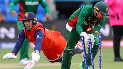 Bangladesh's Nurul Hasan takes the bails off to run out Netherlands' Tom Cooper. AFP