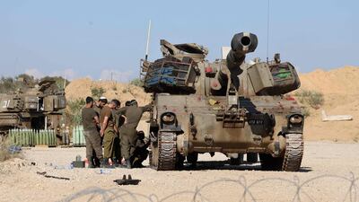 Israeli soldiers and armoured vehicles are posted near the border with the Gaza Strip. AFP
