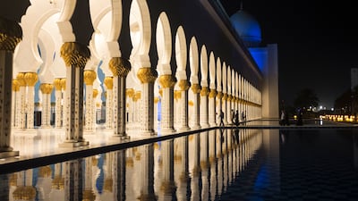 A water feature reflects the intricate arches of Sheikh Zayed Grand Mosque. Reem Mohammed / The National
