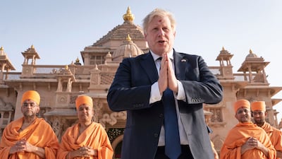 British Prime Minister Boris Johnson walks with Hindu holymen at a temple in Ahmedabad during his two-day trip to India. AP
