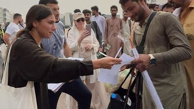 Sophia Sarah Addas helps labourers to fill out their documents so they can head to Makkah for Umrah. All photos: Umrah 4 Labour Workers
