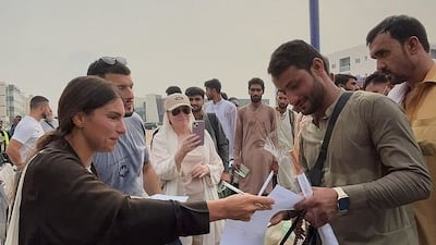 Sophia Sarah Addas (L) helping workers to finish documents to go for Umrah. Photo: Umrah 4 labour Workers