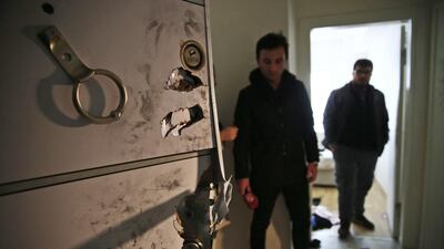 Members of the media and police stand inside the flat where a suspect of New Year’s Day nightclub attack was arrested in Istanbul. Turkish police said they captured the gunman who carried out the deadly New Year’s nightclub attack in Istanbul, with officials saying Tuesday that he’s an Uzbekistan national who trained in Afghanistan and confessed to the massacre. Lefteris Pitarakis / AP Photo