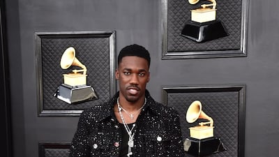 Giveon, wearing black tweed Chanel. AP