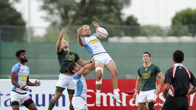 James Little, left, and Lewis Gjaltema, middle, of Speranza take on Werner Kok of South Africa 7s Academy during the International Invitational at the HSBC World Rugby Sevens Series in Dubai. Chris Whiteoak / The National