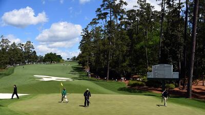 Course workers clean a green during Round 1 of the 80th Masters Golf Tournament at the Augusta National Golf Club on April 7, 2016, in Augusta, Georgia. AFP / Jim Watson