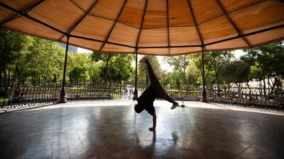 Yamil Maldonado, a breakdancer, practices at a kiosk in Alameda park after being closed off to the public for nearly five months due to the coronavirus pandemic, in Mexico City. AP Photo