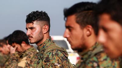 Arab fighters from the Syrian Democratic Forces (SDF) attend the fuenral an another Arab comrade. AFP