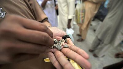 A man chooses his pebbles to throw at pillars during the 'Jamarat' ritual, the stoning of Satan, in Mina near the holy city of Mecca. Fayez Nureldine / AFP