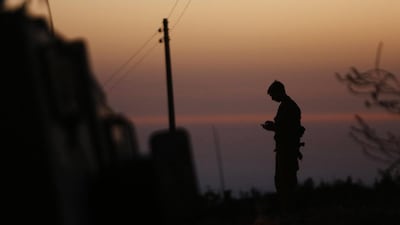An Israeli soldier stands guard near the West Bank city of Hebron. Mussa Qawasma/Reuters