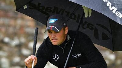 Martin Kaymer of Germany uses an umbrella to shelter from the rain as he prepares to putt during the second round on day two of the 145th Open Championship at Royal Troon on July 15, 2016 in Troon, Scotland. (Photo by Stuart Franklin/Getty Images)