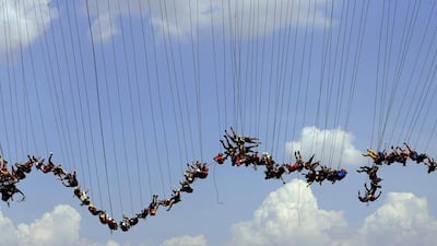 149 people jump off a bridge in an attempt to set a “rope jumping” world record in Hortolandia, Brazil. Paulo Whitaker / Reuters