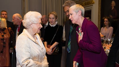 Queen Elizabeth greets singer Annie Lennox at the Royal Academy of Arts in London. Getty