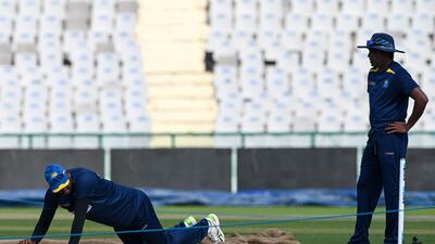Sri Lanka player Angelo Mathews inspects the pitch on the eve of the first Test in Mohali. AFP