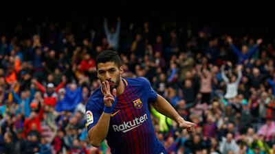 Luis Suarez celebrates scoring Barcelona's opening goal in their 2-1 win over Valencia. Manu Fernandez / AP Photo