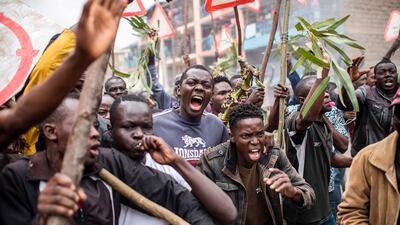 Supporters of the Kenyan opposition presidential candidate shout and hold sticks during a protest in the Mathare slums of Nairobi on August 9, 2017, a day after the presidential election. Luis Tato / AFP