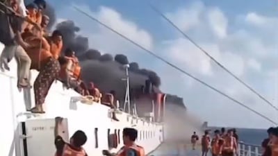 Passengers on the Mutiara Sentosa jump into the sea as a fire spreads on board the ferry. Photo: Screengrab / X