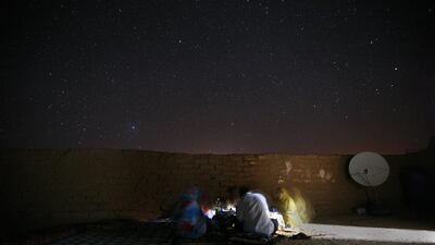 Salek Kori and Mailemnine Kenti, 32, enjoy an evening meal outside Mailemnine’s home in one of the Saharawi Refugee camps in south-west Algeria April 15, 2009. Sammy Dallal / The National