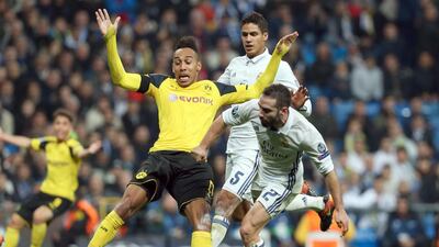 Dortmund's Pierre-Emerick Aubameyang vies for possession with Real Madrid's Raphael Varane and Daniel Carvajal. Friso Gentsch / EPA