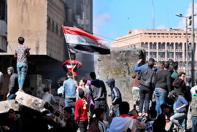 Protesters gather at barriers that block an intended protest site in Baghdad, Iraq on March 2, 2020. AP Photo