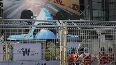 People watch a replay of Nicolas Prost's crash into Nick Heidfeld on the last lap of the Formula E Beijing ePrix on Saturday in China. Andy Wong / AP