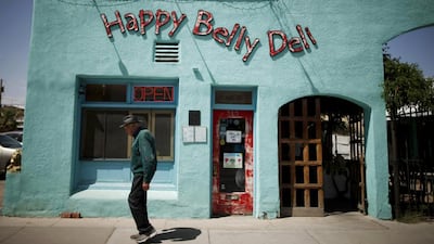 A man walks past the Happy Belly Deli in Truth or Consequences, New Mexico. Many agree that Spaceport America should inject new energy into the town. Lucy Nicholson / Reuters