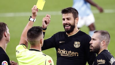Barcelona's Gerard Pique eacts after being shown a yellow card. EPA