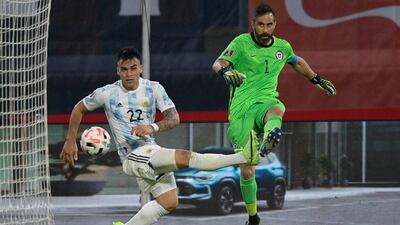 Chile's goalkeeper Claudio Bravo, right, and Argentina's Lautaro Martinez battle for the ball. AP
