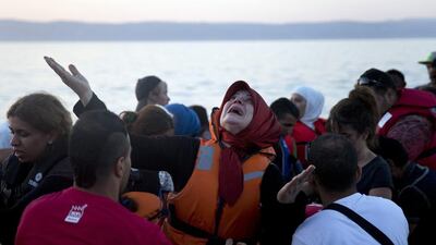 A woman arrives aboard a dinghy after crossing from Turkey to the island of Lesbos, Greece on Saturday, September 19. Petros Giannakouris / AP