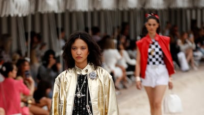 Gold bomber jackets and chequered tops at the Chanel cruise 2022/23 show. Photo: EPA