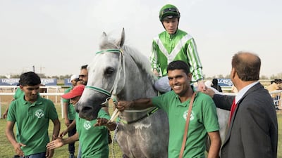 Trainer Irfan Ellahi congratulates jockey Szczepan Mazur for his win while riding Qanoon.