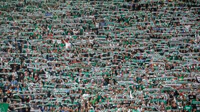 Fans of Rapid Vienna hold up scarves in the stands. Matej Divizna / Getty Images