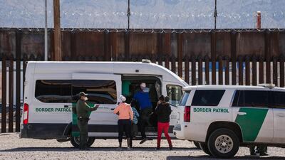 Border Patrol agents apprehend a group of migrants near downtown El Paso, Texas, on March 15, 2021. AFP