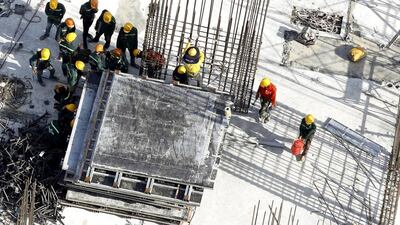 Labourers work at the construction site of an apartment building in Hanoi. Successful property transactions in Vietnam have doubled from a year ago. Kham / Reuters