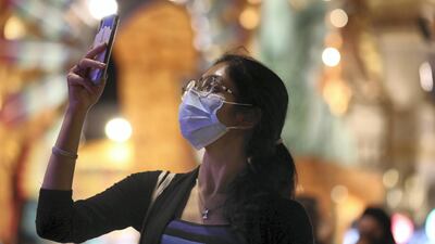 A woman watches as Global Village holds its record-breaking display. Chris Whiteoak / The National
