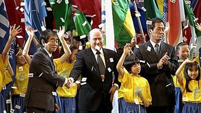 Sepp Blatter, centre, the president of Fifa, loves to take centre stage at ceremonies and draws, as seen here in Tokyo in 1999.