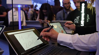 Journalists test the tablet Samsung Galaxy Book after its presentation on February 26, 2017 in Barcelona. AFP