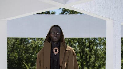 A look in multiple shades of brown is finished with an unexpected brooch. Courtesy Qasimi