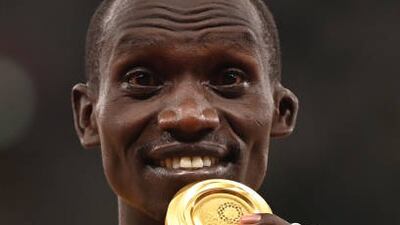 Gold medallist Uganda's Joshua Cheptegei celebrates on the podium during the medal ceremony for the men's 5000m event.