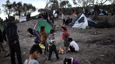 Migrant children, living in a field next door to the Moria camp on the Greek island of Lesbos, playing as they wait to be registered in Mytilene. Over 10,000 unaccompanied migrant children have disappeared in last two years, Europe's police agency Europol said on January 31, 2016. Aris Messinis / AFP